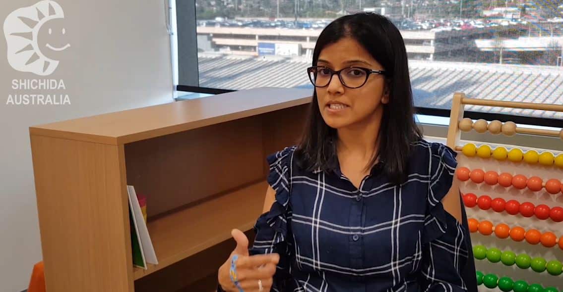 A parent sitting inside a Shichida classroom, sharing a testimonial of the learning journey with Shichida