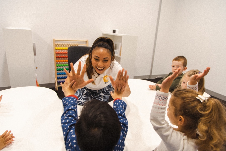 Early Learning Program Instructor giving kids high five's in a Shichida class