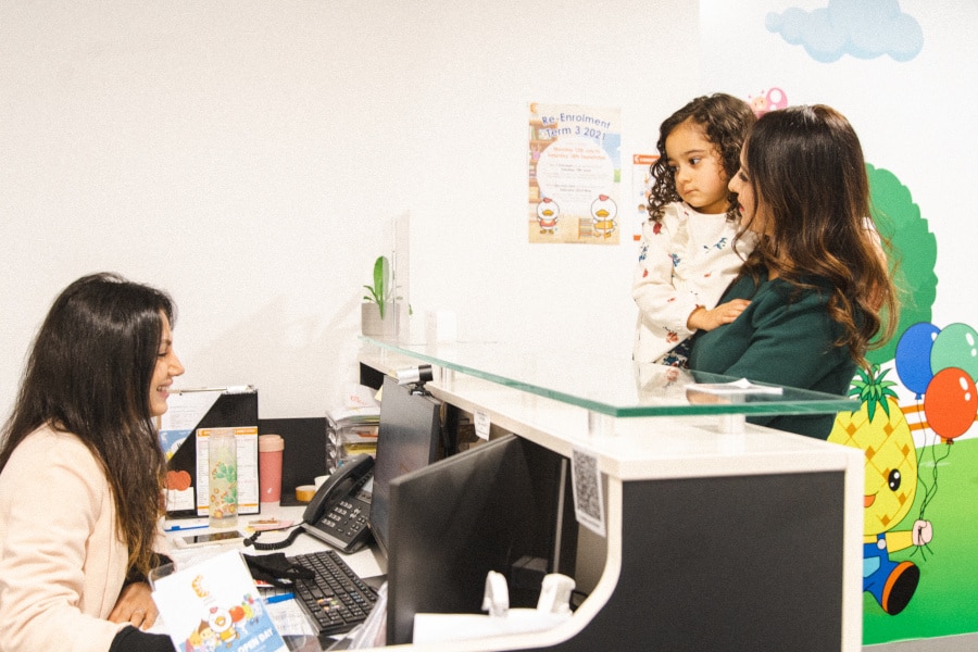 Office Administrator talking to a parent and child in a Shichida centre