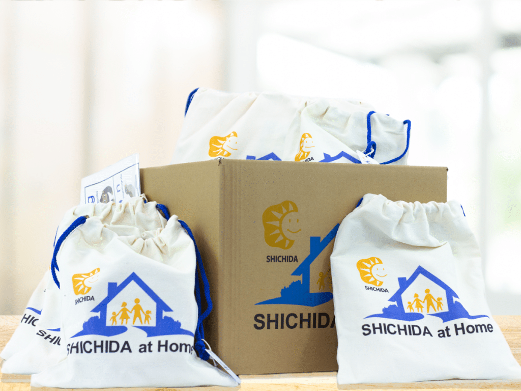 SHICHIDA at Home offers and Optional Toy Bundle purchase - here we see a branded box and branded bags filled with toys