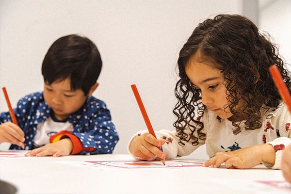 Improving concentration for kids with Shichida classes, here we see 2 preschoolers completing maze, and the yare concentrating and focused
