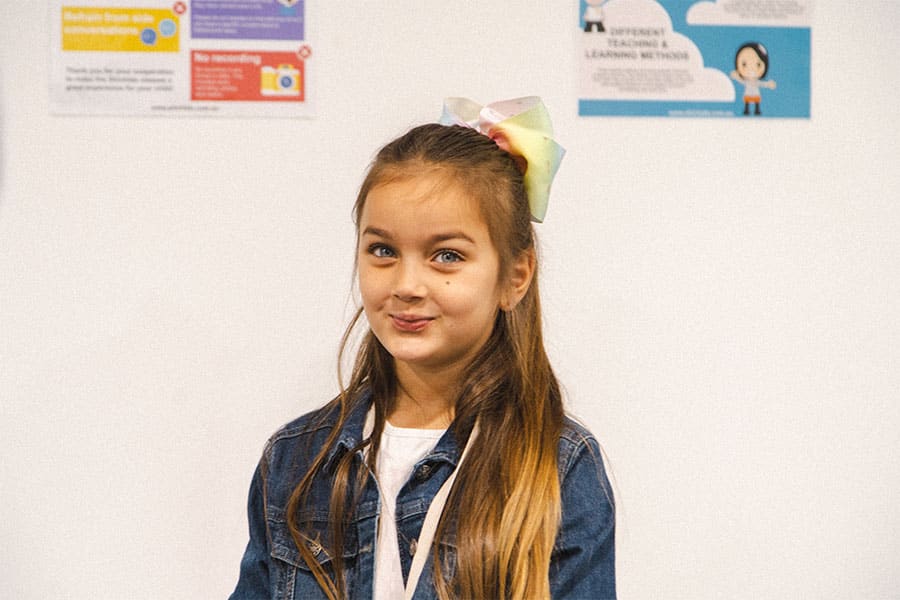Young school aged girl looking towards the camera, in a Shichida centre.