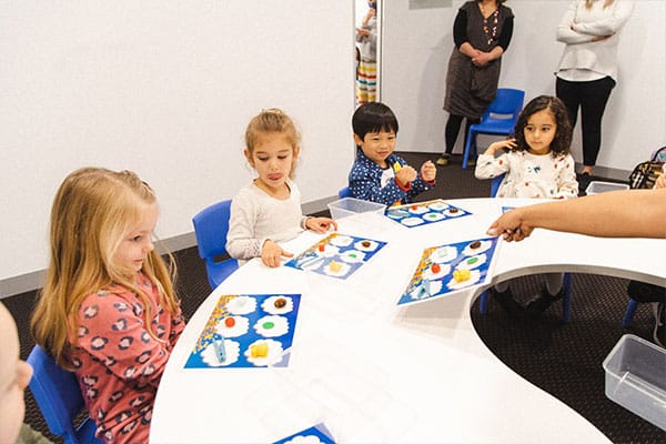Memory Training for children through memory training games, here preschoolers are partaking in a memory matching game in a Shichida class