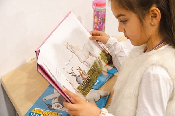 Speed Reading for kids, featuring a preschooler reading a book