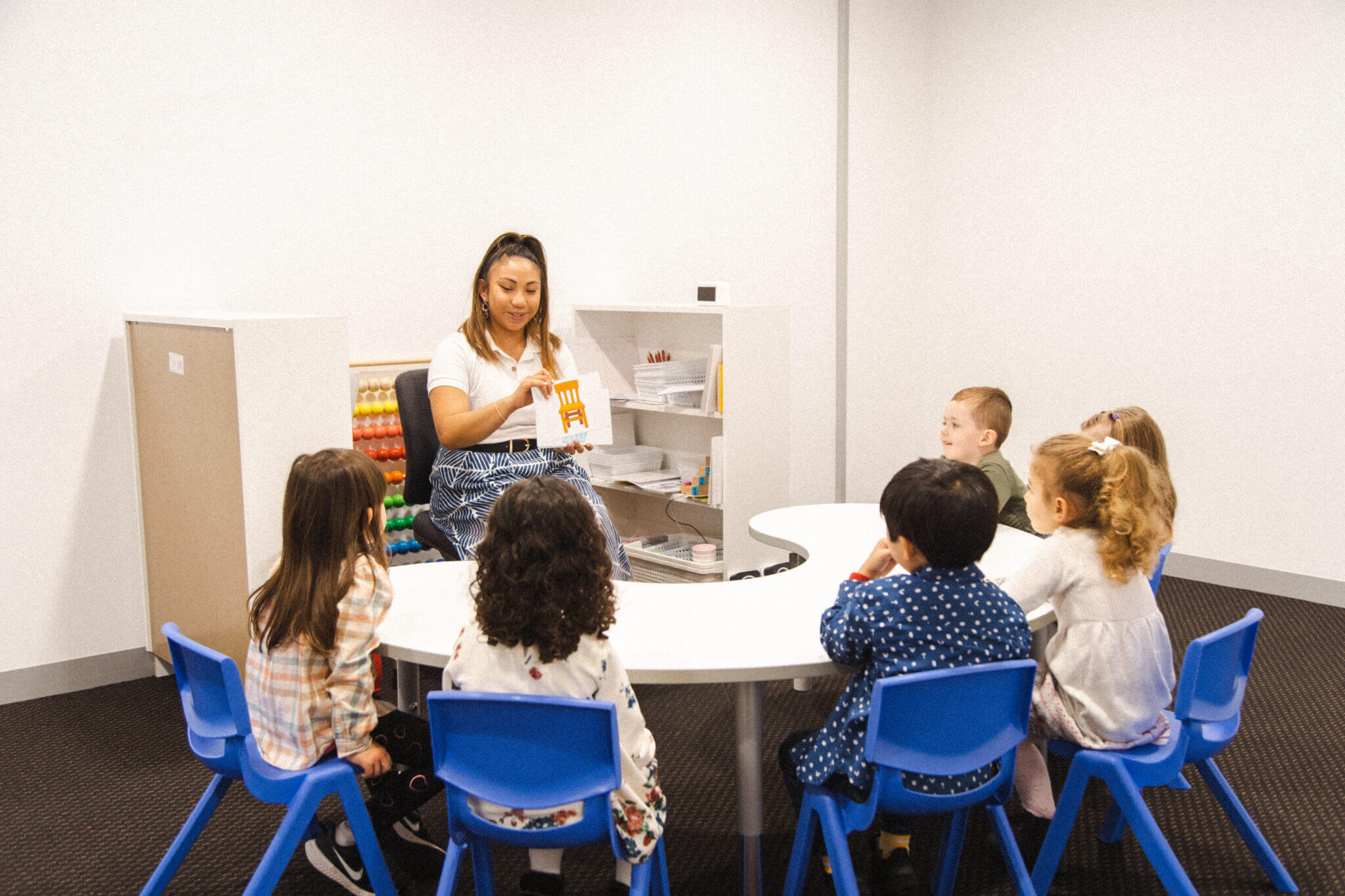 Shichida classroom, teacher showing flashcards to kids