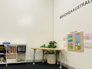 Child waiting area, featuring books, drawing table and activity board