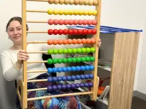 Parramatta Abacus Fun with a Shichida teacher holding a large colourful abacus inside a Shichida class