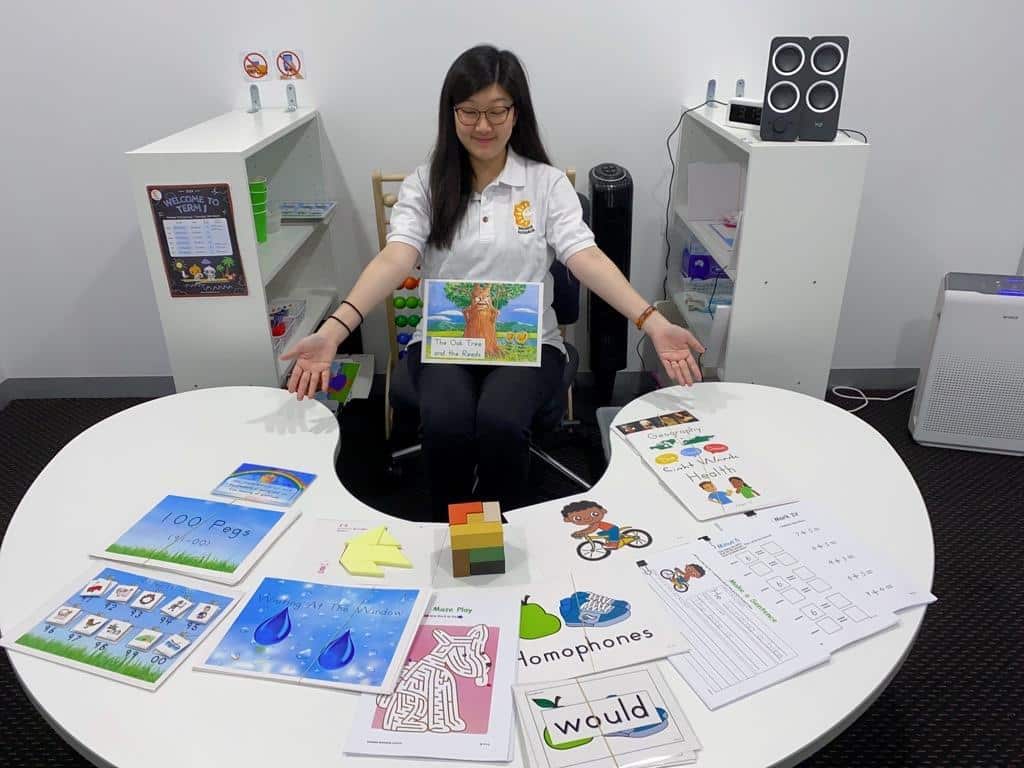 A teacher shows examples of the activities children do at the Shichida Early learning Enrichment Centre in Glen Waverley