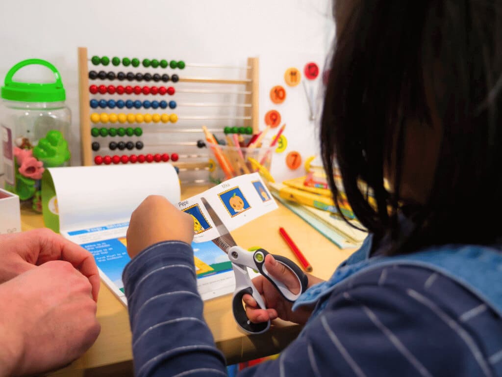 A preschooler works through a fun at-home workbook activity designed to build critical thinking and fine motor control.