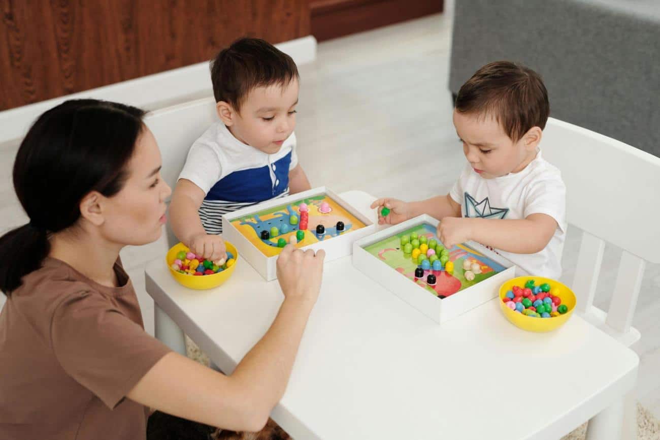 a woman and two children playing with toys