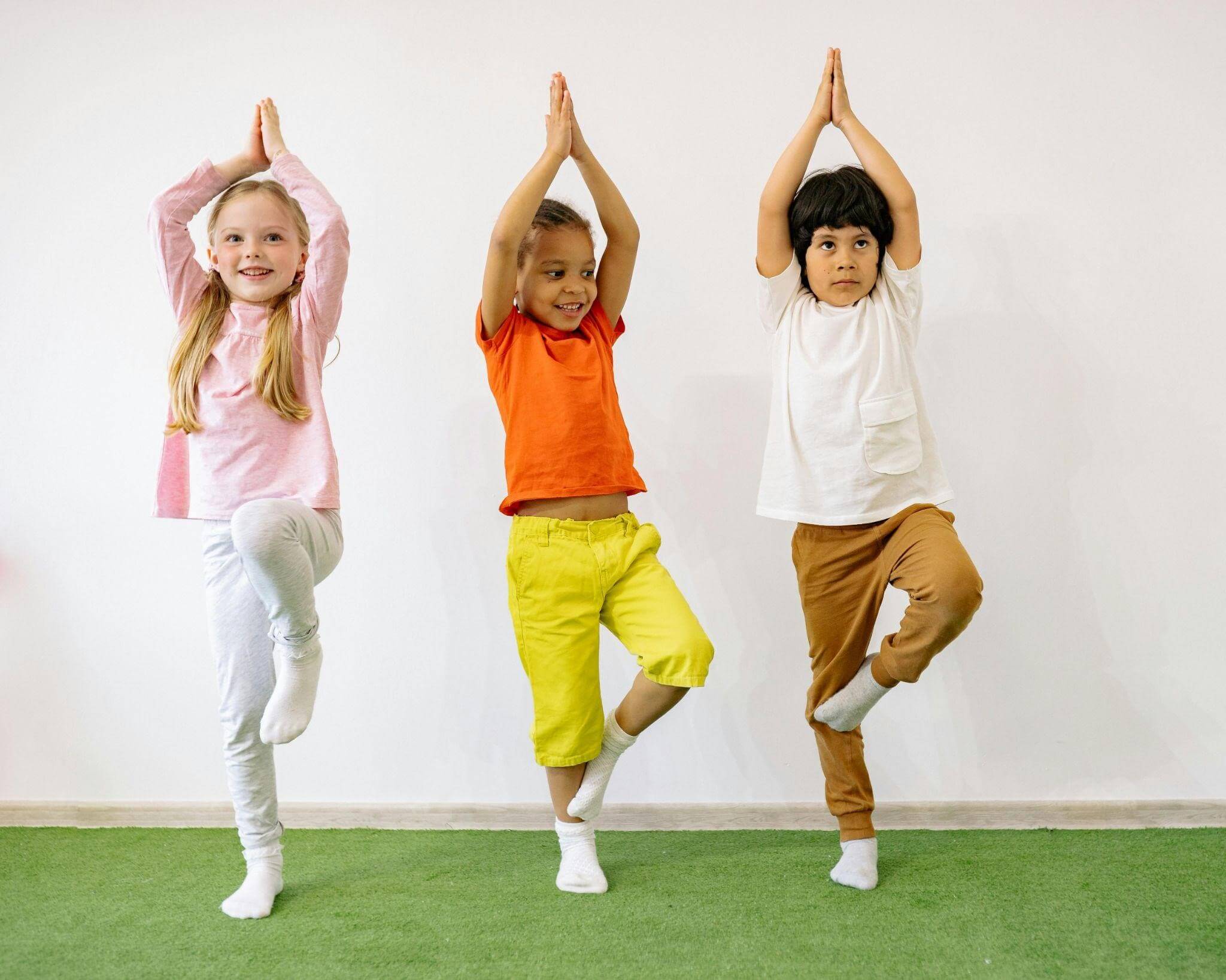 Body parts flashcards, featuring three children practicing yoga poses together in a bright, spacious room.