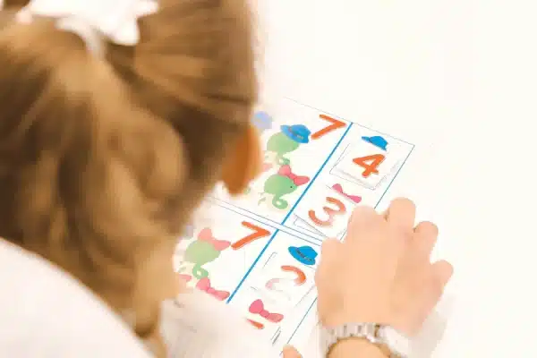 pre-scholer completing a number game