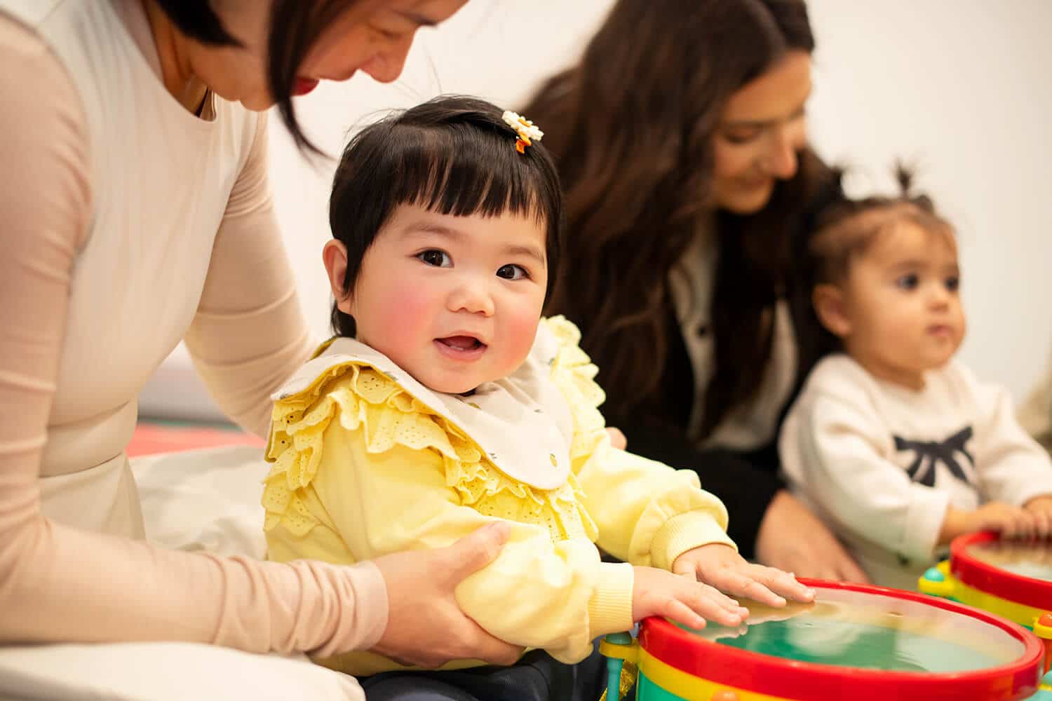 A friendly baby smiles at baby sensory classes
