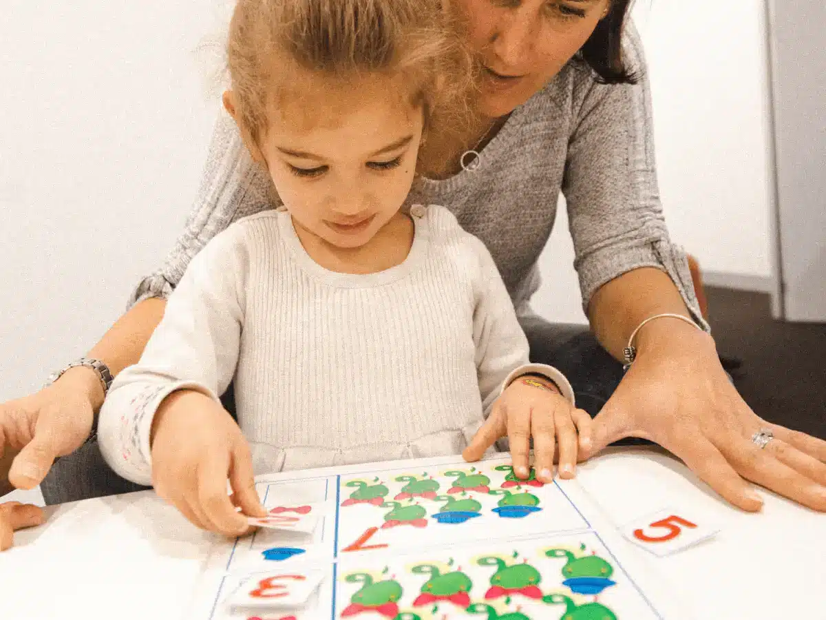 A mum and her preschool daughter playing a number game together during a Shichida Preschool Class.