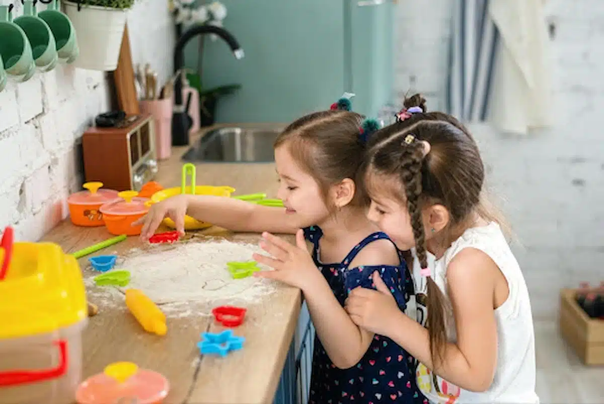Kids playing with flour enjoy a messy sensory experience in early childhood