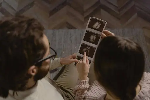 Parents watchin on the ultrasound image