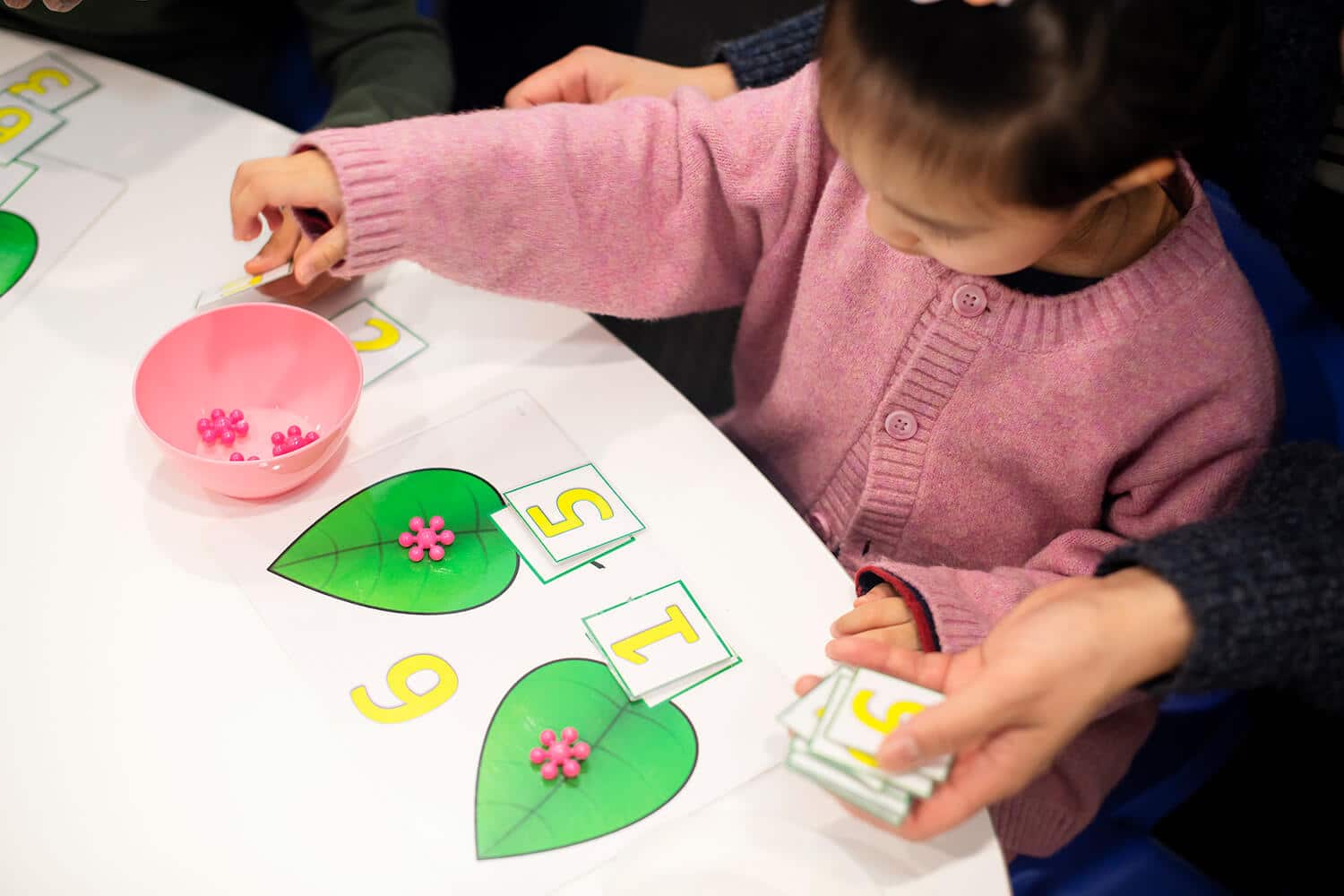 Preschooler Developmental Milestones for ages 3 to 5, a child playing a number game