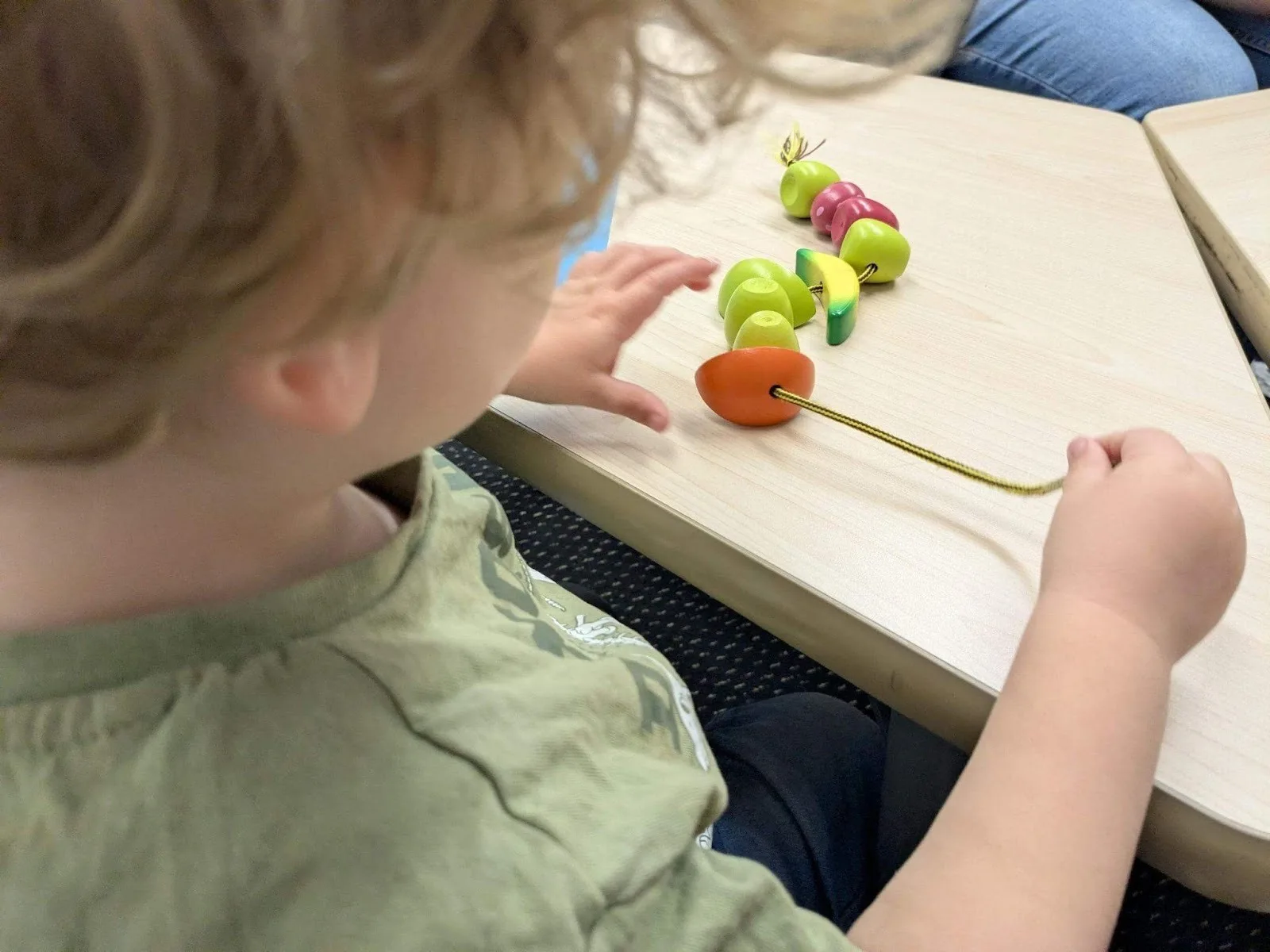 child-plays-with-fruit-toy