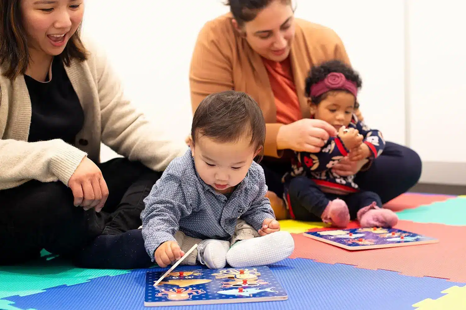 Image by Shichida Australia: Knob puzzles help babies practise memory, focus, fine motor control, and early problem-solving as they work out where each piece belongs. As babies lift, move, and replace puzzle pieces, they begin to understand that objects can change position while still existing - an important step in object permanence and early cognitive development.