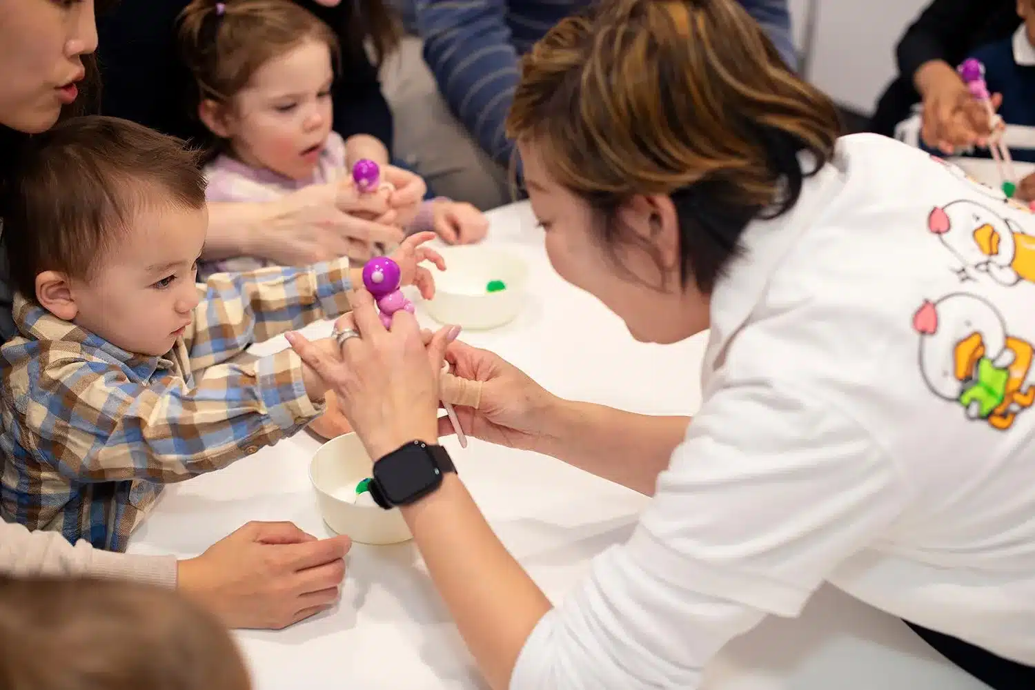 Image by Shichida Australia: A Shichida teacher guides toddlers through a fun and tactile chopsticks game that helps build fine motor skills, focus and hand-eye coordination.